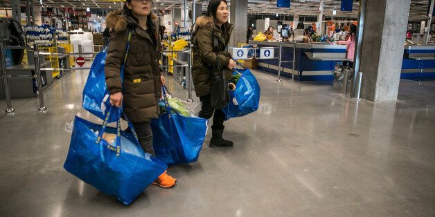 Customers carrying Ikea AB shopping bags leave the company's store in Gwangmyeong, Gyeonggi province, South Korea, on Thursday, Dec. 18, 2014. Ikea, the world's largest home-furnishings retailer, opened its first store in South Korea. Photographer: Jean Chung/Bloomberg via Getty Images