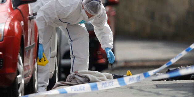 A forensics police officer works next women's shoes and a handbag on the ground behind a police cordon in Birstall near Leeds, June 16, 2016 A British lawmaker was in critical condition after an incident in her constituency in northern England on Thursday, British police said, with media reports suggesting she had been shot and stabbed. Media reports said Jo Cox, 41, who is a lawmaker for the opposition Labour Party, had been attacked as she prepared to hold an advice surgery for constituents in Birstall near Leeds. REUTERS/Phil Noble