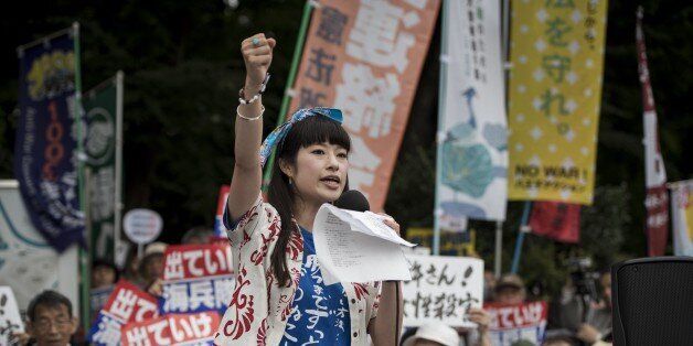 TOKYO, JAPAN - JUNE 19: Anti-U.S. airbase demonstrators protest the U.S. Airbase relocation to Henoko in front of the Japanese Parliament in Tokyo, Japan on June 19, 2016. Protests over the US military presence in Japan have grown more intense over past days due to previous incidents including the alleged rape of a Japanese woman and drunk driving in Okinawa by American military personnel. (Photo by Nicolas Datiche/Anadolu Agency/Getty Images)