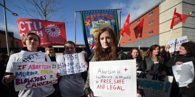 BELFAST, NORTHERN IRELAND - APRIL 07: Pro choice supporters protest outside the Public Prosecution Office on April 7, 2016 in Belfast, Northern Ireland. The protesters gathered in support of a 21 year old Northern Irish woman who was convicted and sentenced earlier this week for procuring a miscarriage. The woman who cannot be named for legal reasons had pleaded guilty to two charges of procuring her own abortion by using a poison and of supplying a poison with intent to procure a miscarriage, she was ten-twelve weeks pregnant at the time. She was given a three-month prison sentence by Judge David McFarland at Belfast high court, which was suspended for two years. Unlike the rest of the United Kingdom, the law in Northern Ireland rules that terminating a pregnancy is illegal except in very limited circumstances. (Photo by Charles McQuillan/Getty Images)