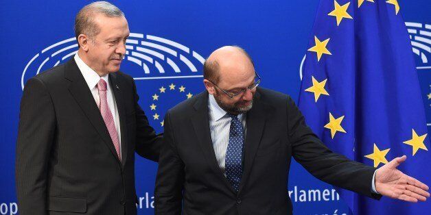 Turkey's President Recep Tayyip Erdogan (L) speaks with European Parliament President Martin Schulz at the European Parliament in Brussels, on October 5, 2015, as part of a meeting with the EU's top officials for urgent talks on the migration crisis and the Syrian war that is producing so many of the refugees. AFP PHOTO /EMMANUEL DUNAND (Photo credit should read EMMANUEL DUNAND/AFP/Getty Images)