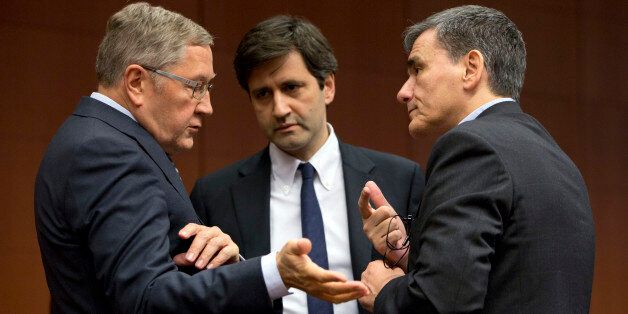 Managing Director of the European Stability Mechanism Klaus Regling, left, speaks with Greece's Finance Minister Euclid Tsakalotos, right, during a meeting of eurogroup finance ministers at the EU Council building in Brussels on Thursday, Jan. 14, 2016. Finance ministers from the nations using the euro met in Brussels Thursday to discuss progress on Greeceâs economic reform program and the results of a review of measures taken by Cyprus to bring its budget into line.(AP Photo/Virginia Mayo)