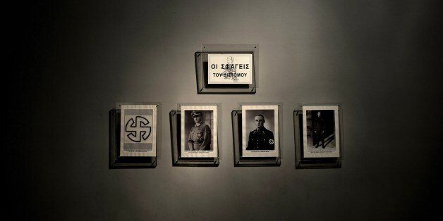 A picture taken on March 27, 2015 in the museum of distomo shows pictures of the Nazi commanders who took part in Distomo massacre during World War II. A small town in central Greece still inhabited today, Distomo has become the symbol of atrocities committed by Nazi troops as they pulled back to Germany in the wake of the Allied Normandy landings in the summer of 1944. On the same day, 650 people including women and children were killed in Ouradour-sur-Glane, a French town that is today twinned with Distomo. A quarter of Distomo's population died -- 218 people including infants and pregnant women who were disemboweled. AFP PHOTO / ARIS MESSINIS (Photo credit should read ARIS MESSINIS/AFP/Getty Images)