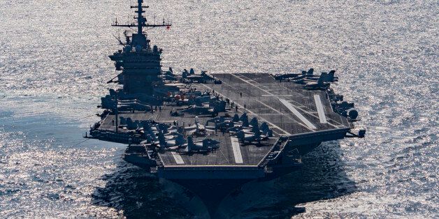 In this Friday, Dec. 25, 2015 photo released by the U.S. Navy, the aircraft carrier USS Harry S. Truman navigates the Gulf of Oman. Iranian naval vessels conducted rocket tests last week near the USS Harry S. Truman aircraft carrier, the USS Bulkeley destroyer and a French frigate, the FS Provence, and commercial traffic passing through the Strait of Hormuz, the American military said Wednesday, Dec. 30, 2015 causing new tension between the two nations after a landmark nuclear deal. (Mass Communication Specialist 3rd Class J. M. Tolbert/ U.S. Navy via AP) MANDATORY CREDIT