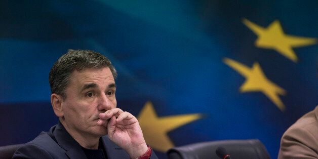 Greek Finance Minister Euclid Tsakalotos listens a question Euclid during a news conference in Athens, on Monday, Jan. 18, 2016. Tsakalotos said Greece was pressing bailout lenders for a swift review of the country's rescue program, arguing that a delay would hurt program implementation and see a slower return to economic growth. (AP Photo/Petros Giannakouris)
