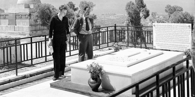 The grave of Eletherios Venizelos, last of the famous Greek statesmen, died in 1936, atop the hill overlooking Canea (Chania), Crete, Greece on April 30, 1947. Sailor Poole and a Gretian companion view the tomb. In the background is the Cretian Statue of Liberty. (AP Photo/Frank Noel)