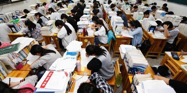 This photo taken on May 24, 2016 shows senior high school students studying at night to prepare for the college entrance exams at a high school in Lianyungang, east China's Jiangsu province. The three-day 2016 college entrance exam will start on June 7. / AFP / STR / China OUT (Photo credit should read STR/AFP/Getty Images)