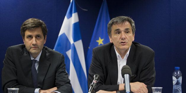 Euclid Tsakalotos, Greece's finance minister, right, speaks during a press conference after a Eurogroup meeting in Brussels, Belgium, on Monday, May 9, 2016. The euro area and the International Monetary Fund will assess whether Greek Prime Minister Alexis Tsipras has made enough budget-tightening commitments to gain another disbursement of emergency loans. Photographer: Jasper Juinen/Bloomberg via Getty Images