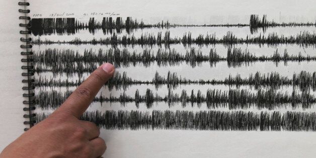 In this July 23, 2013 photo, Gilberto Castelan, director of instrumentation at Mexicoâs National Disaster Prevention Center laboratory, shows a seismic graph from Dec. 18, 2000 when a large eruption was recorded at the Popocatepetl volcano in Mexico City. Sensors feed data to the constantly scrolling seismographs as the crew and volcanologists analyze the concentration of gases and changes in the shape of the mountain. (AP Photo/Marco Ugarte)