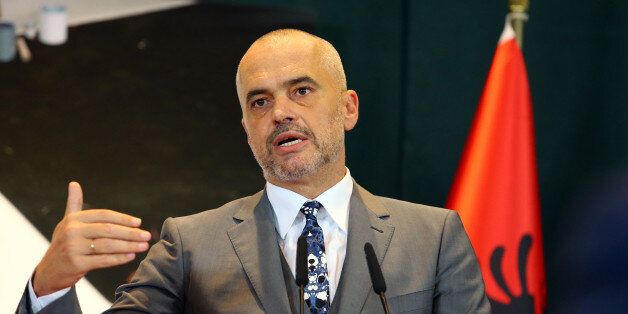 Albanian Prime Minister Edi Rama speaks at the news conference after meeting German Chancellor Angela Merkel on her first stop of the Balkan tour in Tirana Wednesday, July 8, 2015. Merkel has urged Albania fulfill five categories presented by the European Union in December regarding its public administration and justice system ahead of launching full membership talks. Last year Albania was granted the candidate status. (AP Photo/Hektor Pustina)
