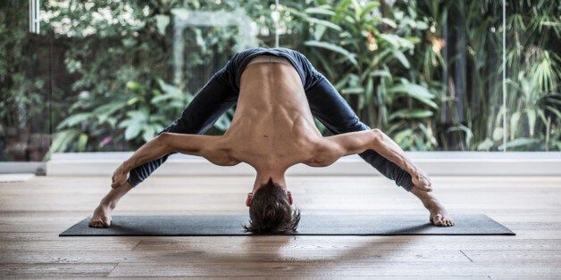 Man doing Prasarita Padottanasana