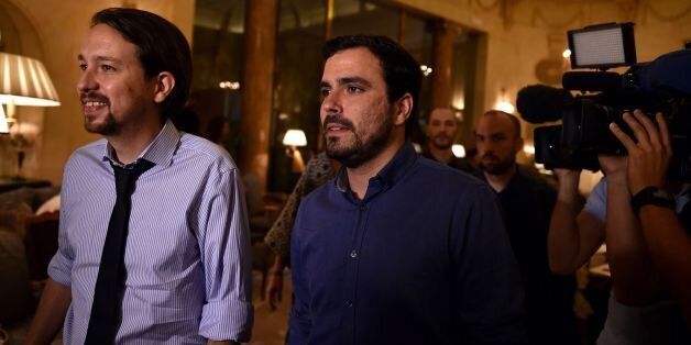 Leader of left wing party Podemos Pablo Iglesias (L) and leader of Izquierda Unida IU (United Left) Alberto Garzon arrive at the Ritz Hotel prior to an economic forum on June 6, 2016 in Madrid, four days ahead of the start of the electoral campaign.Podemos, a close ally of Greece's ruling Syriza party, in May formed an alliance with Izquierda Unida, a coalition led by the countrys communist party, to run together in the June 26 elections. / AFP / GERARD JULIEN (Photo credit should read GERARD JULIEN/AFP/Getty Images)