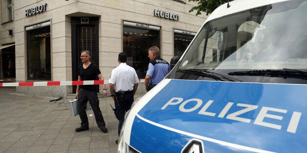 BERLIN, GERMANY - MAY 28: Police crime scene investigators secure the entrance to a Hublot luxury watch store after a robbery on May 28, 2016 in Berlin, Germany. A car was driven into the front door of the main entrance of the shop in the Kurfuerstendamm (also known as Ku'damm) shopping district of the city. According to witnesses, three assailants allegedly stole goods from the store after ramming in its front door, and fled in a waiting Audi automobile and on foot. Shots were heard at the scene, which police say were fired from a starter pistol. (Photo by Adam Berry/Getty Images)