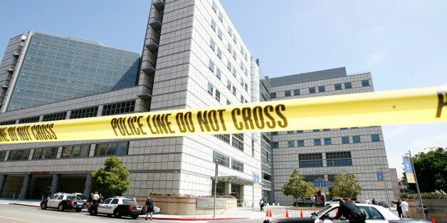 Police tape hangs across the street near the emergency room dock at UCLA Medical Center in Los Angeles June 25, 2009. Michael Jackson had taken ill at his home and found not breathing by paramedics who rushed him to the hospital. He was pronounced dead after arriving at the hospital in full cardiac arrest, Los Angeles coroner Fred Corral told CNN on Thursday. REUTERS/Mario Anzuoni (UNITED STATES ENTERTAINMENT)