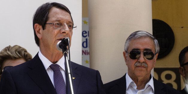 Greek Cypriot President Nicos Anastasiades speaks as Turkish Cypriot leader Mustafa Akinci (R) listens during a social function in Nicosias UN-patrolled buffer zone on June 2, 2016. Cypriot leaders agreed in the meeting to resume their stalled peace talks on June 8 after President Nicos Anastasiades had suspended the UN-brokered negotiations. Talks were shelved after Anastasiades snubbed a dinner held for state leaders at a UN-organised humanitarian summit in Istanbul when he found out that Akin