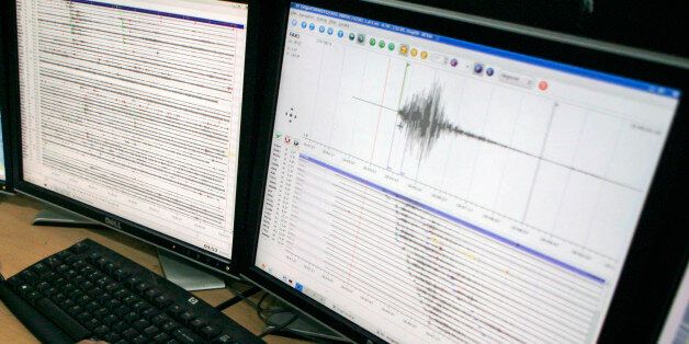 Indonesian scientists look at a computer screen showing the spikes on the seismograph caused by early Sunday's earthquake near the town of Manokwari, Papua province, at a meteorological office in Jakarta, Indonesia, Sunday, Jan. 4, 2009. A series of powerful earthquakes at dawn Sunday killed at least four people and injured dozens more in remote eastern Indonesia, cutting power lines and destroying buildings.(AP Photo/Dita Alangkara)