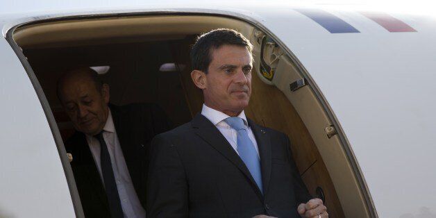 French Prime Minister Manuel Valls steps out from his airplane followed by Defence Minister Jean-Yves Le Drian upon their arrival in Amman on October 11, 2015. Valls arrived in Amman on the second le of visits to three Middle East nations aimed at boosting economic ties and holding talks on regional conflicts. AFP PHOTO / KENZO TRIBOUILLARD (Photo credit should read KENZO TRIBOUILLARD/AFP/Getty Images)