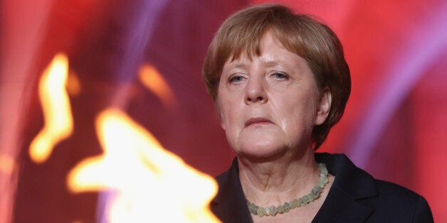 VERDUN, FRANCE - MAY 29: German Chancellor Angela Merkel and French President Francois Hollande (not pictured) look on after lighting an eternal flame inside the ossuary at Douaumont in memory of the 130,000 soldiers whose remains are buried at the site during ceremonies to commemorate the 100th anniversary of the World War I Battle of Verdun on May 29, 2016 near Verdun, France. The 1916, 10-month battle pitted the French and German armies against one another in a grueling campaign of trench warfare and artillery bombardments that killed a total of approximately 300,000 soldiers. The events today coincide with the 50th anniversary of commemorations held at Verdun by then French President Charles de Gaulle and German Chancellor Konrad Adenauer that paved the way for a new era of peaceful, post-war Franco-German relations. (Photo by Sean Gallup/Getty Images)