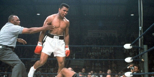 FILE - In this May 25, 1965, file photo, heavyweight champion Muhammad Ali is held back by referee Joe Walcott, left, after Ali knocked out challenger Sonny Liston in the first round of their title fight in Lewiston, Maine. Ali, the magnificent heavyweight champion whose fast fists and irrepressible personality transcended sports and captivated the world, has died according to a statement released by his family Friday, June 3, 2016. He was 74. (AP Photo/File)