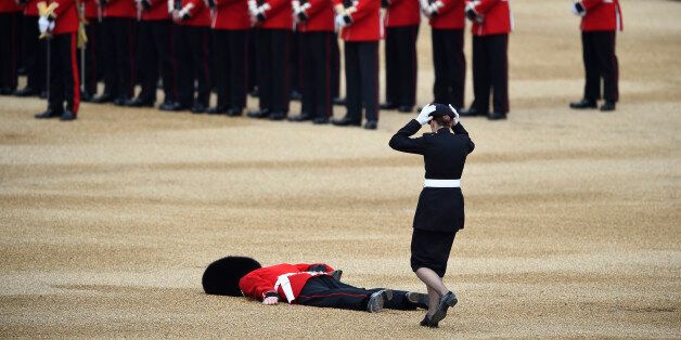 A Guardsman faints at Horseguards Parade for the annual Trooping the Colour ceremony in central London, Britain June 11, 2016. Trooping the Colour is a ceremony to honour Queen Elizabeth's official birthday. The Queen celebrates her 90th birthday this year. REUTERS/Dylan Martinez