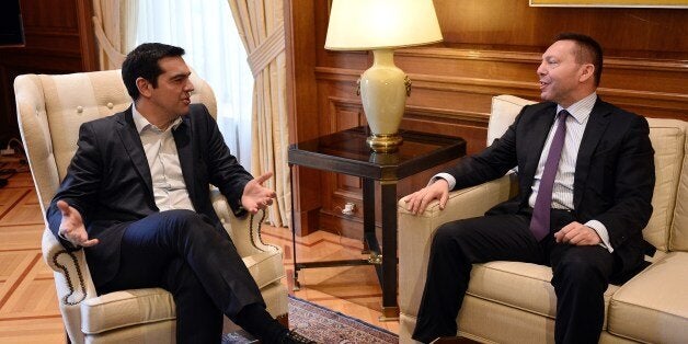 Greece's prime minister Alexis Tsipras (L) talks with the chairman of the Bank of Greece, Yiannis Stournaras during their meeting in Athens on March 6, 2015 after Athens got no help from the European Central Bank to address a cash squeeze. The ECB recently cut off a key channel of financing for Greek banks, saying it would no longer accept Greek sovereign bonds as collateral for loans. Greek Prime Minister Alexis Tsipras has requested a meeting with European Commission chief Jean-Claude Juncker