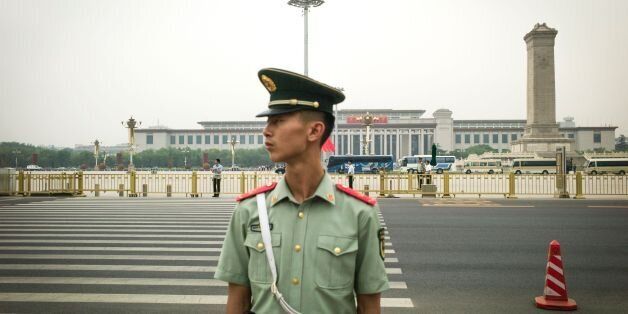 A Chinese paramilitary guard stands in Tiananmen Square in Beijing on June 3, 2016, on the eve of the 27th anniversary of the June 4, 1989 crackdown on pro-democracy protests. / AFP / FRED DUFOUR (Photo credit should read FRED DUFOUR/AFP/Getty Images)