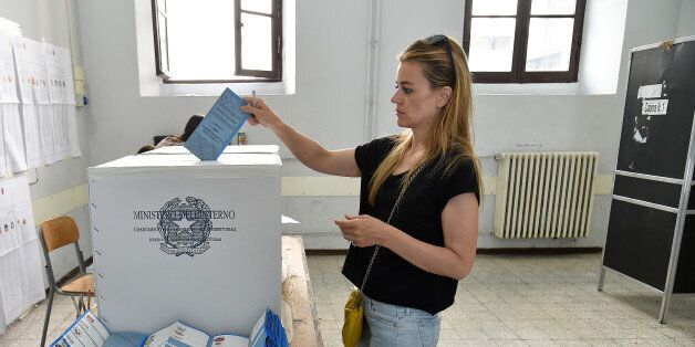 A woman casts her ballot on the first round of the election for Mayor of Rome, on June 5, 2016 at a polling station in central Rome.Italian Prime Minister Matteo Renzi's party was locked in battle on Sunday for control of Rome and other cities in municipal elections seen as a test for the ruling party and the country's divided right. / AFP / ALBERTO PIZZOLI (Photo credit should read ALBERTO PIZZOLI/AFP/Getty Images)