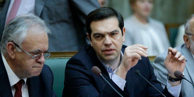 Greece's Prime Minister Alexis Tsipras, right, speaks with Deputy Prime Minister Giannis Dragasakis during his government cabinet meeting in Athens, Tuesday, May 10, 2016. European finance ministers on Monday debated for the first time measures to ease Greece's massive debt burden amid concern the International Monetary Fund might withdraw from the bailout talks. (AP Photo/Thanassis Stavrakis)