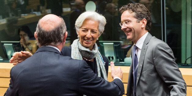 Managing Director of the International Monetary Fund Christine Lagarde, center, greets Spanish Economy Minister Luis de Guindos, left, and Dutch Finance Minister Jeroen Dijsselbloem during a meeting of eurogroup finance ministers at the European Council LEX building in Brussels on Monday, June 22, 2015. Heads of state in the eurogroup meet in Brussels on Monday for a special summit to discuss the financial crisis with Greece. (AP Photo/Geert Vanden Wijngaert)