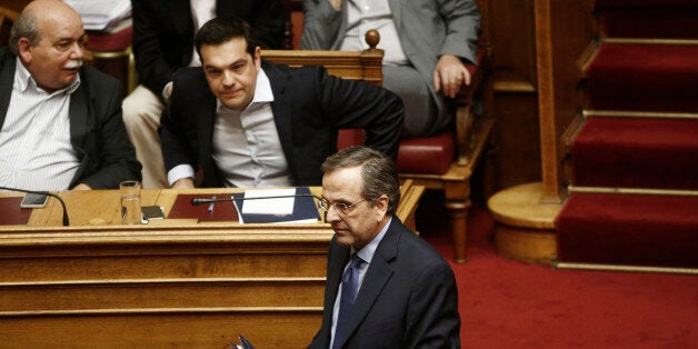 Antonis Samaras, Greece's former prime minister, front center, walks past Alexis Tsipras, Greece's prime minister, rear second left, after delivering his speech inside the Greek parliament in Athens, Greece, on Sunday, June 28, 2015. European finance chiefs shelved efforts to rescue Greece, turning their focus to containing fallout from a looming financial collapse as Greek savers lined up at local banks and ATMs to pull out as many euros as they could. Photographer: Kostas Tsironis/Bloomberg vi