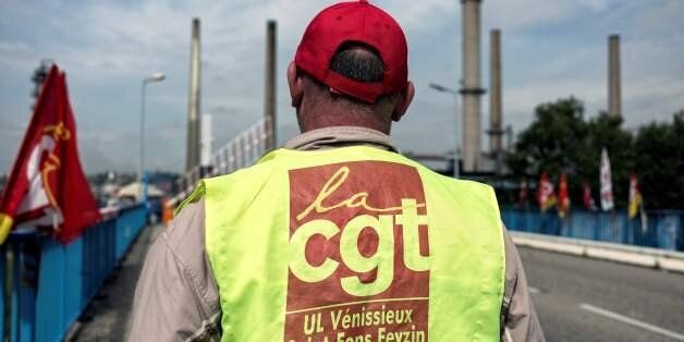 A CGT union striking worker stands in front of the Total refinery of Feyzin, on May 25, 2016 during a protest against the government's planned labour law reforms. France has been using strategic fuel reserves for two days in the face of widespread blockades of oil depots by union activists, the head of the oil industry federation said on May 25, 2016. / AFP / JEFF PACHOUD (Photo credit should read JEFF PACHOUD/AFP/Getty Images)