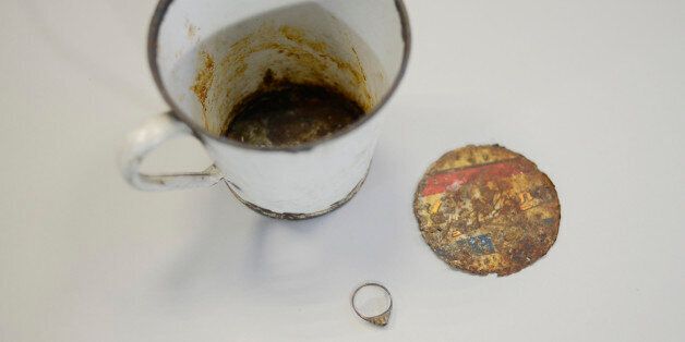 A gold ring that was found by curators of Auschwitz - Birkenau Museum in a metal mug with double bottom is pictured on May 19, 2016 in Oswiecim. More than 70 years after the liberation of the World War II camp in occupied Poland, staff discovered the jewellery in a rusting enamel mug, one of thousands of pieces of kitchenware now on display at the museum. / AFP / BARTOSZ SIEDLIK (Photo credit should read BARTOSZ SIEDLIK/AFP/Getty Images)