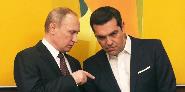 Greek Prime Minister Alexis Tsipras , right, chats with Russian President Vladimir Putin during their meeting in Athens, Friday, May 27, 2016. On his first trip to a European Union country this year, Russian President Vladimir Putin traveled to Greece Friday to visit a secluded Christian Orthodox monastic sanctuary and eye energy and privatization deals in the cash-strapped country.(Orestis Panagiotou/EPA via AP)