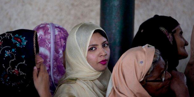 Women stand in a queue to receive free food distributed at a local shrine in Islamabad, Pakistan, Thursday, April 7, 2016. Hundreds of families get food from these outlets donated by people. (AP Photo/B.K. Bangash)