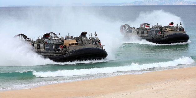 US Navy hovercrafts approach the beach at the beginning of the NATO Trident Juncture exercise 2015 at Raposa Media beach in Pinheiro da Cruz, south of Lisbon, Wednesday, Oct. 20, 2015. NATO Allies and partner nations join forces for the next three weeks for the Alliance's Trident Juncture live military exercise involving 36,000 troops from more than 30 nations across Portugal, Italy and Spain. (AP Photo/Steven Governo)