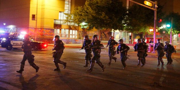 Riot police respond to anti-Trump protests following a rally and speech by Republican presidential candidate Donald Trump, in front of the Albuquerque Convention Center where the event was held, in Albuquerque, N.M., Tuesday, May 24, 2016. (AP Photo/Brennan Linsley)