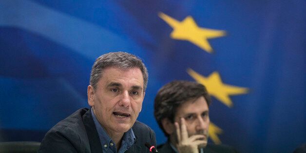Greek Finance Minister Euclid Tsakalotos, left speaks next to deputy Finance Minister Giorgos Houliarakis during a news conference about Greece's bailout program, in Athens, Thursday, May 26, 2016. Bailout-dependent Greece has agreed to carry out new austerity measures and reforms to secure vital rescue loans from its European creditors. (AP Photo/Petros Giannakouris)