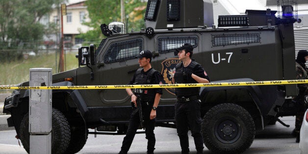 Turkish police officers secure the area at the site of a blast, in Istanbul, Thursday, May 12, 2016. A car bomb targeting a vehicle carrying military personnel lightly wounded several people Thursday, an official said. The explosion occurred inside a car close to the entrance of a military garrison in Istanbul's Sancaktepe neighborhood at the start of the evening rush hour. None of the injured were in a serious condition. (AP Photo)