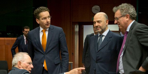German Finance Minister Wolfgang Schaeuble, left, speaks with Dutch Finance Minister Jeroen Dijsselbloem, second left, and Luxembourg's Finance Minister Pierre Gramegna, right, during a meeting of eurogroup finance ministers at the EU Council building in Brussels on Thursday, Jan. 14, 2016. Finance ministers from the nations using the euro met in Brussels Thursday to discuss progress on Greeceâs economic reform program and the results of a review of measures taken by Cyprus to bring its budget into line.(AP Photo/Virginia Mayo)