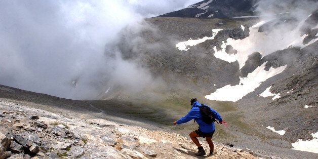 A German hiker walks down a slope of Mount Olympus, at 2,500 meters (8,200 feet) in northern Greece, on Sunday, June 19, 2005. Olympus, Greece's tallest mountain at 2,917 meters (9,570 feet) was the mythological home of the ancient Greek gods. (AP Photo/Petros Giannakouris)