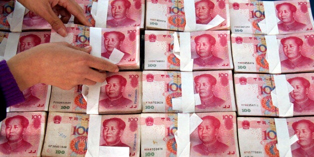 In this photo taken on Dec. 9, 2010, an employee counts Renminbi banknotes at a Rural Credit Cooperative office in Tancheng of Linyi City, east China's Shandong Province. China increased interest rates Saturday, Dec. 25, 2010 for the second time in little more than two months as the government steps up its fight against rising inflation that could threaten political stability. (AP Photo/Xinhua, Zhang Chunlei) NO SALES