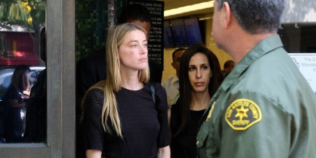 Actress Amber Heard leaves Los Angeles Superior Court court on Friday, May 27, 2016, after giving a sworn declaration that her husband Johnny Depp threw her cellphone at her during a fight Saturday, striking her cheek and eye. The judge ordered Depp to stay away from his estranged wife and ruled that Depp shouldn't try to contact Heard until a hearing is conducted on June 17. Heard filed for divorce on Monday. (AP Photo/Richard Vogel)