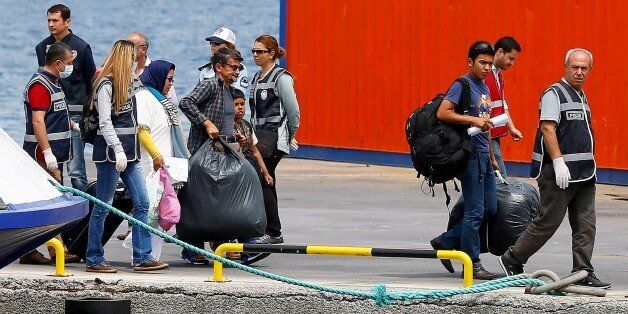 IZMIR, TURKEY - MAY 20: 23 refugees who were sent from Greece are transfered to camps after their procedures at assent point within refugees change and readmission between Turkey - European Union agreement in Dikili district of Izmir, Turkey on May 20, 2016. (Photo by Cem Oksuz/Anadolu Agency/Getty Images)