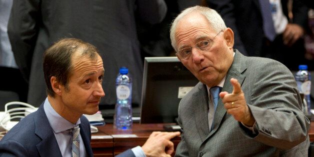 German Finance Minister Wolfgang Schaeuble, left, speaks with Dutch State Secretary for Finance Eric Wiebes during a meeting of EU finance ministers in Brussels on Wednesday, May 25, 2016. Eurozone finance ministers struck a deal early Wednesday clearing the way for Greece to access a fresh round of bailout funds, while also laying out debt relief measures aimed at securing the involvement of the International Monetary Fund, or IMF. (AP Photo/Virginia Mayo)
