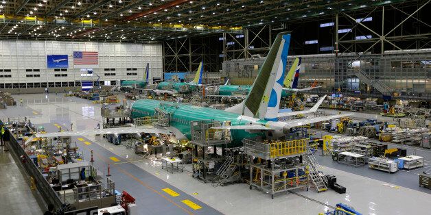 In this photo taken Monday, Dec. 7, 2015, the second Boeing 737 MAX airplane being built is shown on the assembly line in Renton, Wash. U.S. industrial production dropped for the third straight month in December 2015, as utilities reduced output amid unusually warm weather and energy companies cut back in the face of falling oil prices. Industrial production, which includes manufacturing, mining and utilities, contracted 0.4 percent after retreating a revised 0.9 percent the previous month, the Federal Reserve reported Friday, Jan. 15, 2016. (AP Photo/Ted S. Warren)