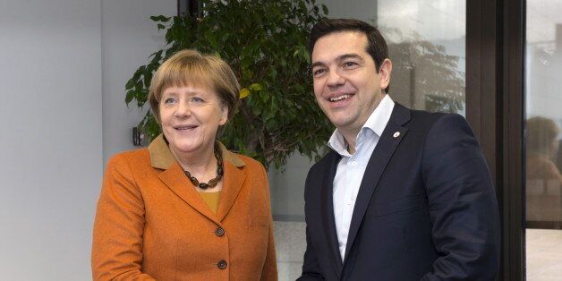 Germany's Chancellor Angela Merkel poses with Greece's Prime Minister Alexis Tsipras (R) during a EU-Turkey summit in Brussels, as the bloc is looking to Ankara to help it curb the influx of refugees and migrants flowing into Europe, March 7, 2016. REUTERS/John Thys/Pool