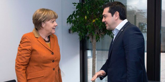 German Chancellor Angela Merkel (L) speaks with Greek Prime Minister Alexis Tsipras (R) during a European Union leaders' summit with Turkey on the migrants crisis at the European Council in Brussels, on March 7, 2016.EU leaders held a summit with Turkey's prime minister on March 7 in order to back closing the Balkans migrant route and urge Ankara to accept deportations of large numbers of economic migrants from overstretched Greece. The European Union is hardening its stance in a bid to defuse t