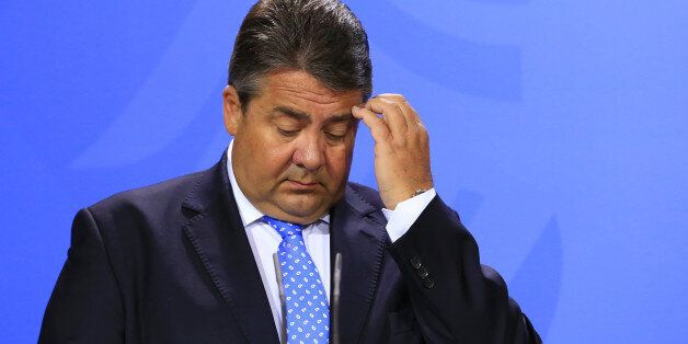 Sigmar Gabriel, Germany's economy and energy minister, pauses during a news conference following a two-day cabinet retreat in Meseburg, Germany, on Wednesday, May 25, 2016. In the latest response to the refugee crisis that's dogged German Chancellor Angela Merkel since last summer, her cabinet on Wednesday backed legislation that includes stricter requirements for asylum seekers to integrate into German society. Photographer: Krisztian Bocsi/Bloomberg via Getty Images *** Sigmar Gabriel