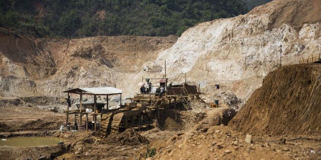 Miners work on a rock washing and separating machine at the Lian Shan open pit ruby mine in Mogok, Mandalay, Myanmar, on Tuesday, March 15, 2016. In a remote region of Myanmar, a country that is estimated to produce 90% of the world's ruby supply, there is a place where gem reigns supreme. Mogok, about 280 miles north of the capital Napyidaw, is economically reliant on mining, gem-cutting and jewelry making - giving it the title 'Ruby Land.' Photographer: Taylor Weidman/Bloomberg via Getty Images