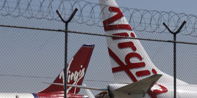 Virgin planes are parked next to each other at Kingsford Smith airport in Sydney in this August 30, 2013 file photo. REUTERS/Daniel Munoz/File Photo